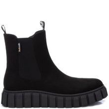 A black Chelsea-style ankle boot with a thick lug sole, shown in a side profile on a white background. A small 'Furmash' brand tag is visible on the side elastic panel.
