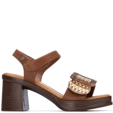 Brown sandal with a decorative buckle on a white background