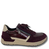 A low-top sneaker by Riddler, featuring a mix of burgundy patent leather and burgundy suede panels, beige side stripes, a beige heel tab, and a silver zipper on the side.