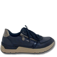 A navy blue slip-on sneaker with a metallic silver heel accent, a silver zipper closure, and a beige midsole, shown from a side profile on a white background.