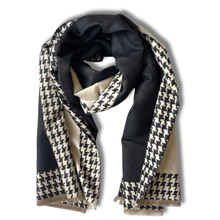 Black and beige houndstooth patterned scarf on a white background
