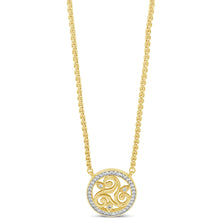 A gold necklace with a circular pendant featuring a triple swirl motif and a border of small clear stones, shown on a plain white background.