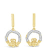 A pair of gold dangle earrings with a circular design paved with clear stones and a small gold crown at the bottom, shown on a plain white background.