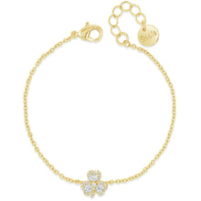 A delicate yellow gold chain bracelet with a small four-leaf clover charm paved with clear stones, displayed on a clean white background. The bracelet features a lobster clasp, an extender chain, and a round engraved tag.
