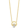 A gold necklace featuring a circular pendant with a central floral motif set with clear gemstones, displayed on a clean white background.