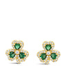 A pair of gold shamrock stud earrings with green heart-shaped emerald-cut stones and small clear accent stones, shown on a plain white background.