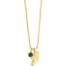 A gold chain necklace featuring a small gold bear silhouette pendant and a round green gemstone charm, displayed on a clean white background.