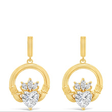 A pair of gold drop earrings featuring a circular ring with a small gold heart-shaped cluster set with clear heart-shaped gemstones, shown on a plain white background.