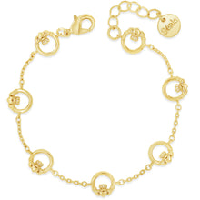 A delicate gold chain bracelet featuring multiple small circular links, each adorned with a tiny flower motif, displayed on a clean white background. One of the circular links is engraved with the brand name 'cléop'.