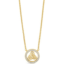 A gold necklace featuring a circular pendant with a triquetra knot design surrounded by a halo of small clear stones, shown on a plain white background.