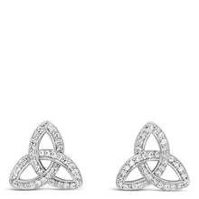 A pair of polished silver huggie hoop earrings shown on a light gray background, with one earring displaying the front curve and the other showing the side profile and post.