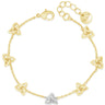A delicate yellow gold chain bracelet featuring seven small triquetra knot charms and a central silver-colored butterfly charm, displayed on a clean white background.