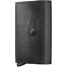 A black leather bi-fold wallet, shown closed, featuring a snap-button closure and a debossed 'SEMPER' logo on the front, set against a plain white background.