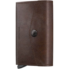 A dark brown leather wallet with a snap-button closure and a visible 'RE:INVIT' logo on the front, shown against a plain white background.