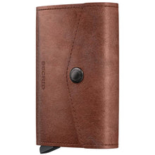 A brown leather wallet with a snap-button closure and a visible 'REDGEEK' brand stamp on the front, shown against a plain white background.