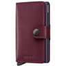 A Secrid Miniwallet in burgundy leather with a dark navy blue pen slot and snap closure, shown on a plain white background.