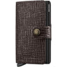 A dark brown textured leather wallet case with a crocodile pattern, featuring a snap-button strap closure and a black pen inserted on the side, shown against a plain white background.