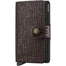 A dark brown textured leather wallet case with a crocodile pattern, featuring a snap-button strap closure and a black pen inserted on the side, shown against a plain white background.