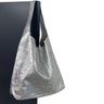 Silver metallic tote bag on a black background
