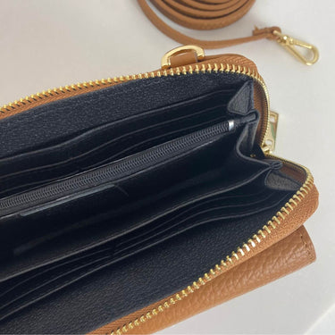 Brown leather wallet with gold zipper on a white background