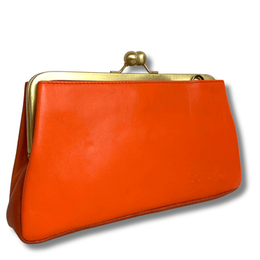 Orange clutch purse with gold clasp on a white background