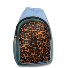 Backpack with leopard print pattern on a light blue background
