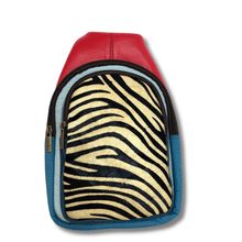 Backpack with red top section, zebra pattern middle section, and blue bottom section on a white background