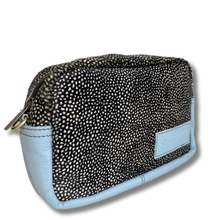 Small pouch with black and white patterned top half and light blue bottom half on a white background