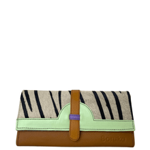 Clutch bag with zebra pattern and brown leather strap on a white background