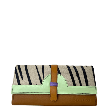 Clutch bag with zebra pattern and brown leather strap on a white background