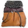 Two-tone backpack with polka dot top section on a white background
