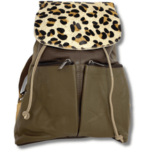Brown leather backpack with a leopard print flap on a white background
