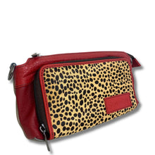 A red leather pouch with a leopard print front panel and a red leather brand patch that reads 'Sopiny'.