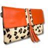Orange clutch with leopard print strap on a white background