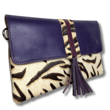 Purple and animal print clutch bag with tassel on a white background