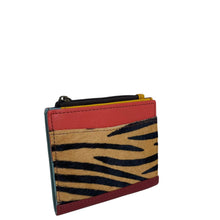 A small zippered card holder wallet featuring a red leather top, a tan and black zebra print front panel, and a dark blue side panel, shown on a plain white background.