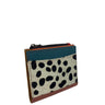 A small zip-around wallet with a color-blocked design featuring a teal blue top section, a black-and-white cowhide patterned front panel, and reddish-brown leather trim, shown on a plain white background.