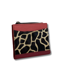 Small pouch with red border and giraffe pattern on a white background