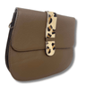 Brown leather handbag with a leopard print strap on a white background