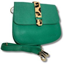 Green leather handbag with a leopard print strap on a white background