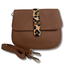 Brown leather bag with a leopard print strap on a white background