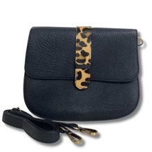 Black leather handbag with a leopard print strap on a white background