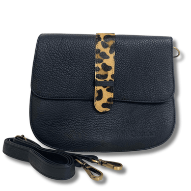 Black leather handbag with a leopard print strap on a white background