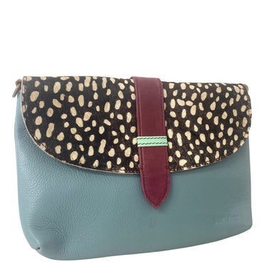 Clutch bag with spotted flap and turquoise body on a white background