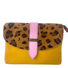 Clutch bag with leopard print top half and yellow bottom half on a white background