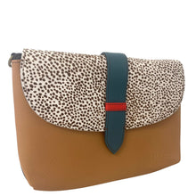 Clutch bag with spotted flap and brown body on a white background