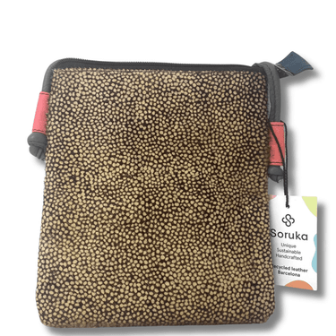 Patterned pouch with a visible brand tag on a white background