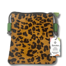 Leopard print pouch with green accents and Soruka label on a white background