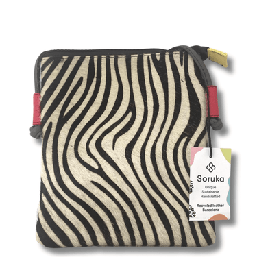 Zebra-patterned pouch with red accents and a visible brand tag on a white background