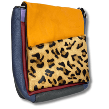 Multicolored bag with leopard print section on a white background
